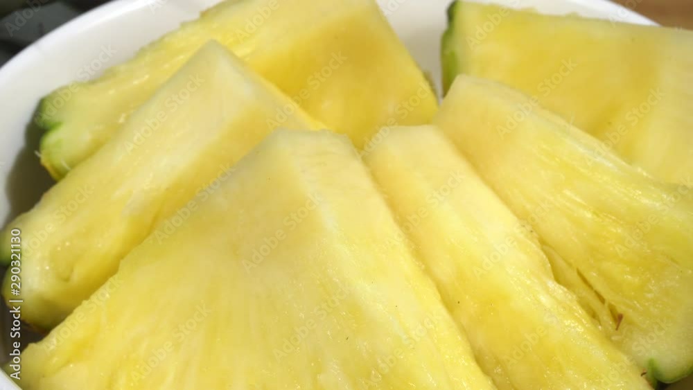 Piña cortada en trozos en un bol de cerámica Piña cortada en trozos en un bol de cerámica