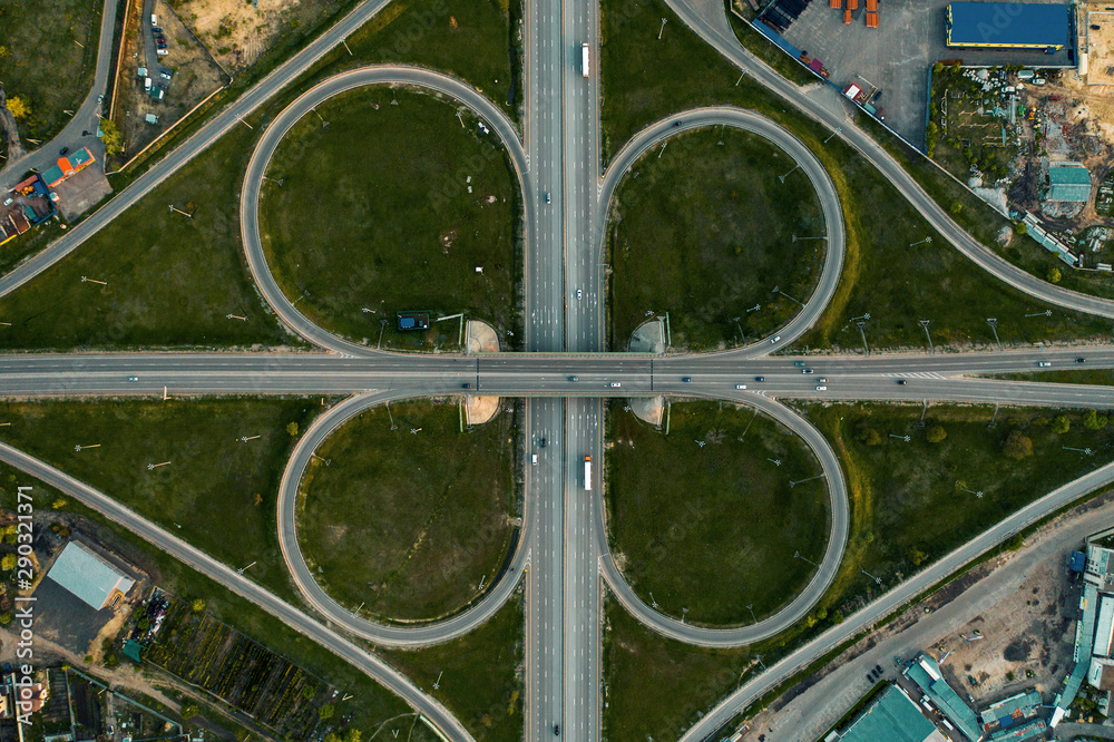 Road car traffic on crossroad or intersection or transport junction with circle movement, aerial top view