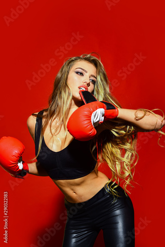 Boxer woman. Beautiful woman with red boxing gloves training. Sportsman, woman boxer fighting in gloves. Sport, boxing and fitness concept. Boxer MMA female fighter. Sporty sexy girl in boxing gloves.