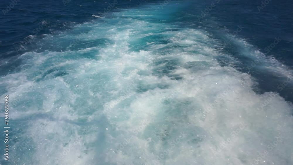 A water trail is formed using a boat. A water trail foams behind a boat