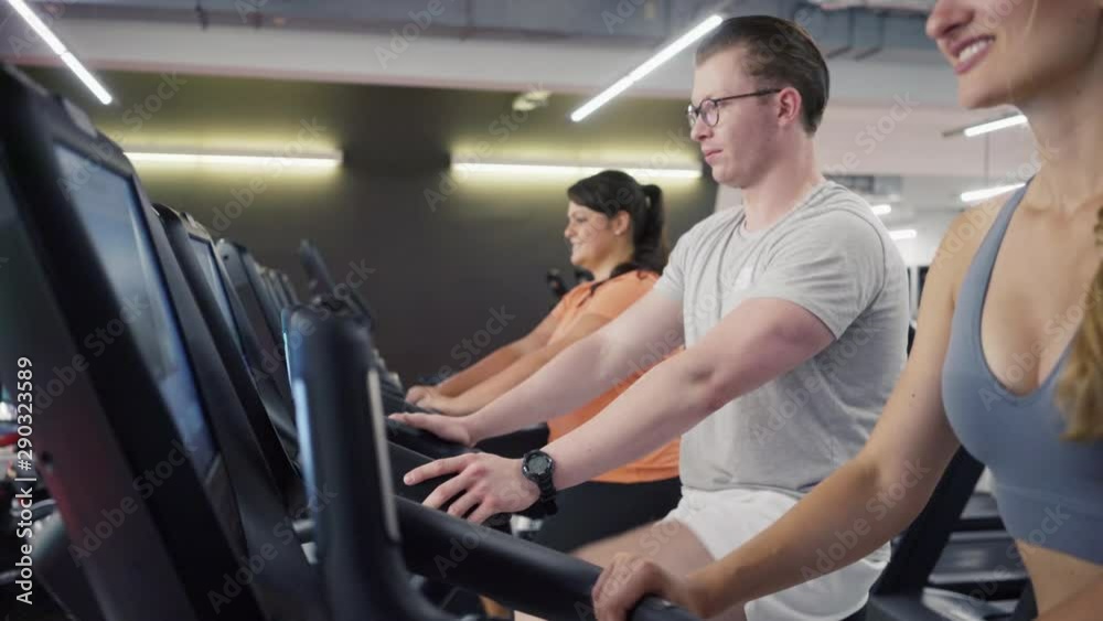People on fitness bikes with their instructor People on fitness bikes with their instructor