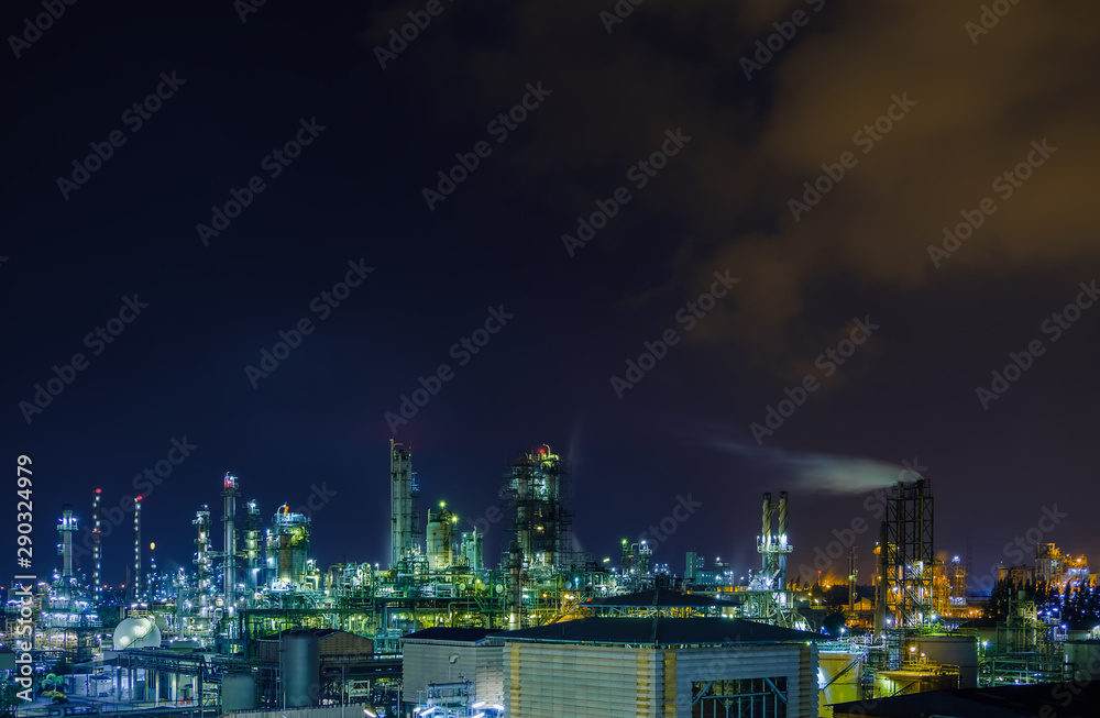 Glitter lighting of petrochemical plant at night, Manufacturing of petroleum industrial plant with twilight sky background, Oil and gas refinery plant