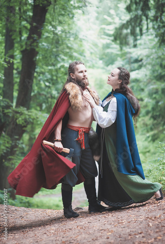 Brave Warrior Viking man with beautiful medieval woman outdoor
