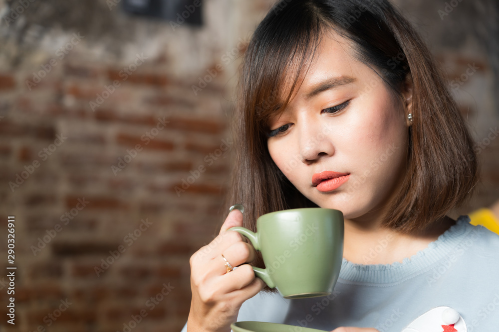 Pretty female drinking coffee in cozy cafe during lunch Pretty female drinking coffee in cozy cafe during lunch