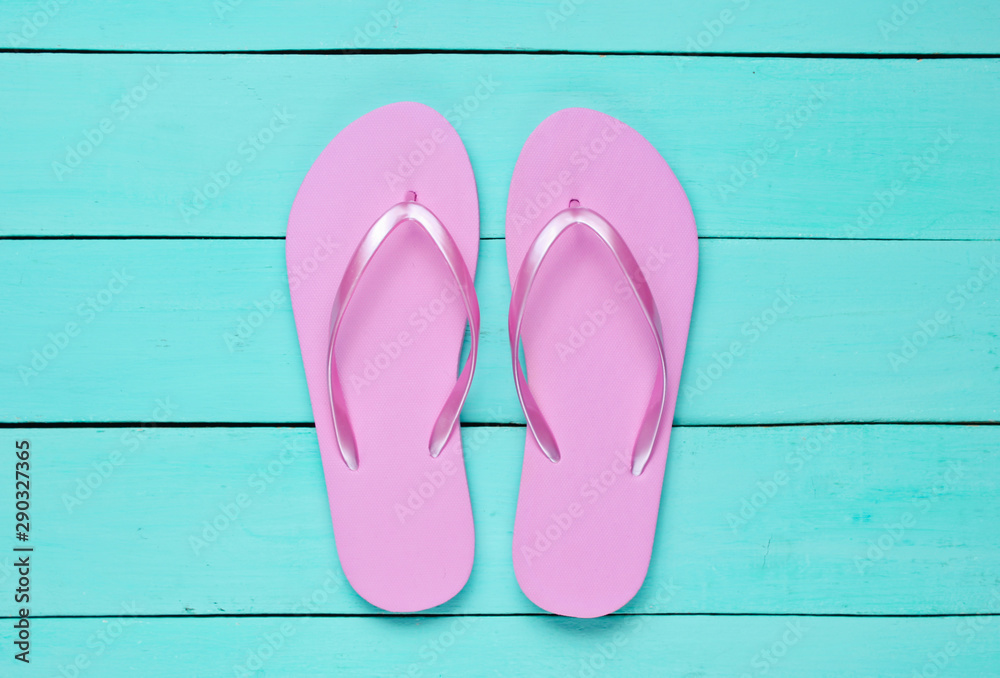 Tropical beach lifestyle. Flip flops on blue wooden background. Summer background. Top view Tropical beach lifestyle. Flip flops on blue wooden background. Summer background. Top view
