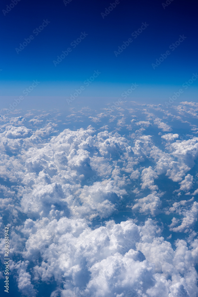 White clouds and blue sky, a view from airplane window White clouds and blue sky, a view from airplane window