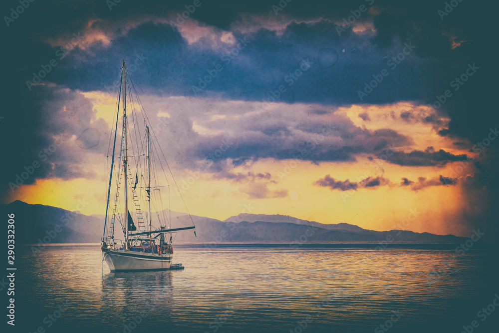 Old photo in vintage style as a Natural background. There is a Yacht in the Mediterranean sea at sunrise, Cagliari, Italy. he sun illuminates the island with beautiful golden colors.