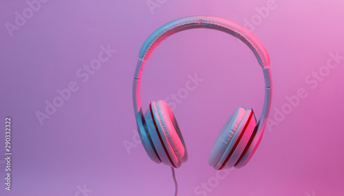 Classic wired headphones with gradient blue pink neon light. Retro style.Retro wave. 80s. Minimalistic music concept.