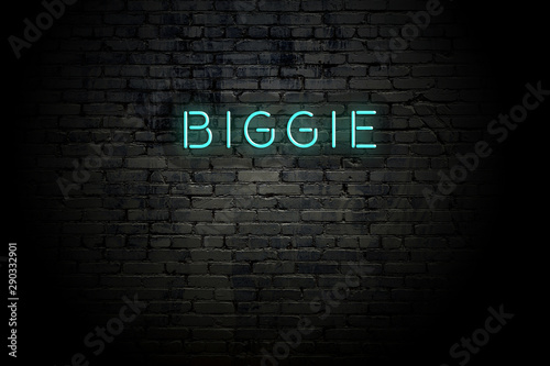 Highlighted brick wall with neon inscription biggie photo