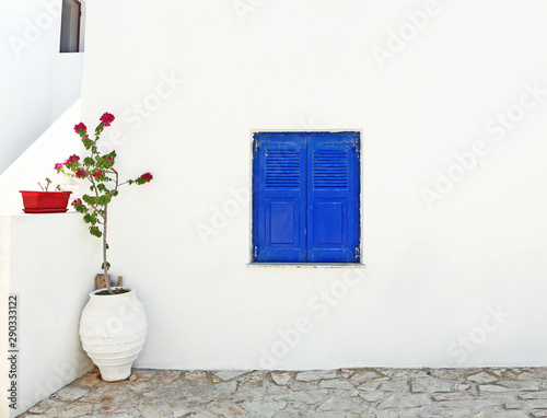 traditional architecture - blue wooden window and bougainvilleas at Ano Koufonisi Greece