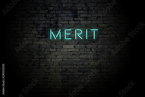 Highlighted brick wall with neon inscription merit
