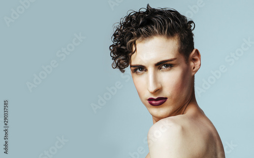 Portrait of a young  model with make up, isolated on gray