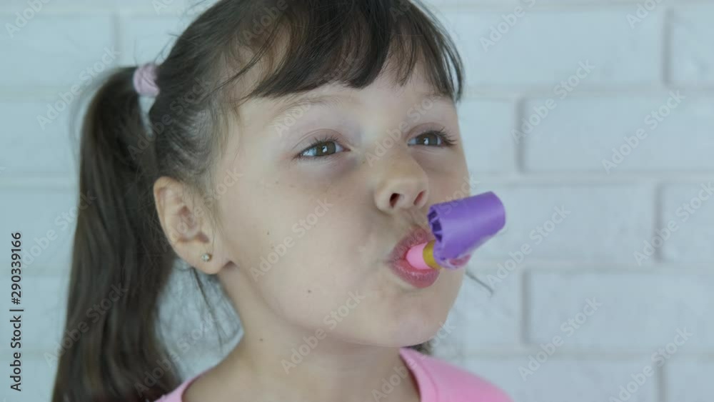 Kid with party blower. Happy little girl with a party horn. Stock Video ...