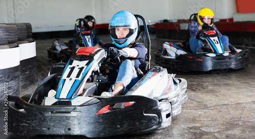 Young people driving sport cars for karting