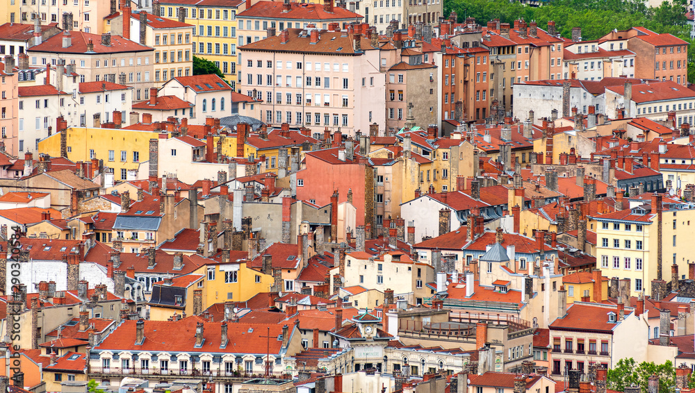 Red roofs and stone chimneys are the traditional architecture of the historic center of the french city of Lyon as well as many old European towns
