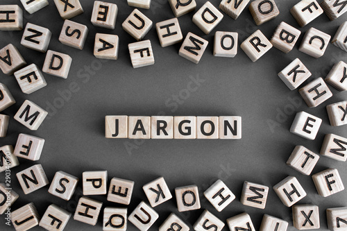 Jargon  - word from wooden blocks with letters,  special words and phrases jargon concept, random letters around, top view on grey background photo
