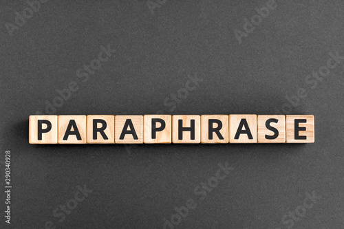 paraphrase - word from wooden blocks with letters, rewrite retelling using other paraphrase words concept,  top view on grey background photo