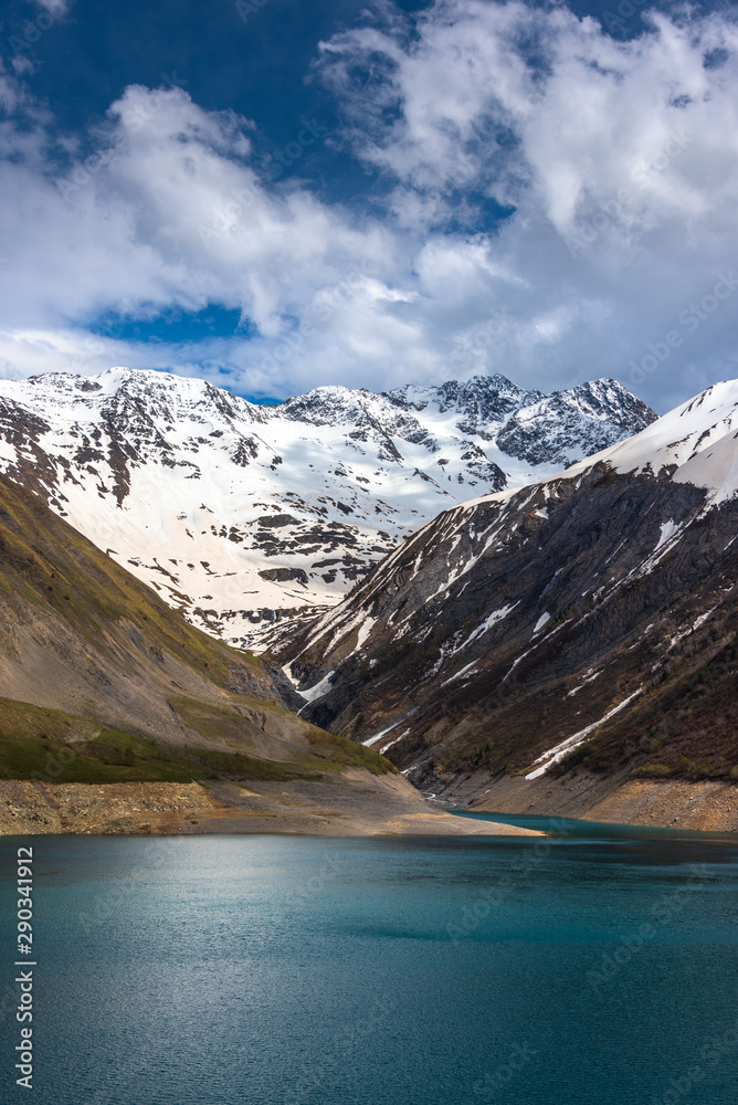 Snow and glaciers melt in the mountains and fill a reservoir (in this case the Lac de Grand Maison in the French Alps  in the Isère region)