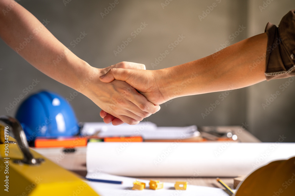 Group of officer teamwork is happy and shake hands to celebrate in success of finish in job planning about home building construction project Group of officer teamwork is happy and shake hands to celebrate in success of finish in job planning about home building construction project