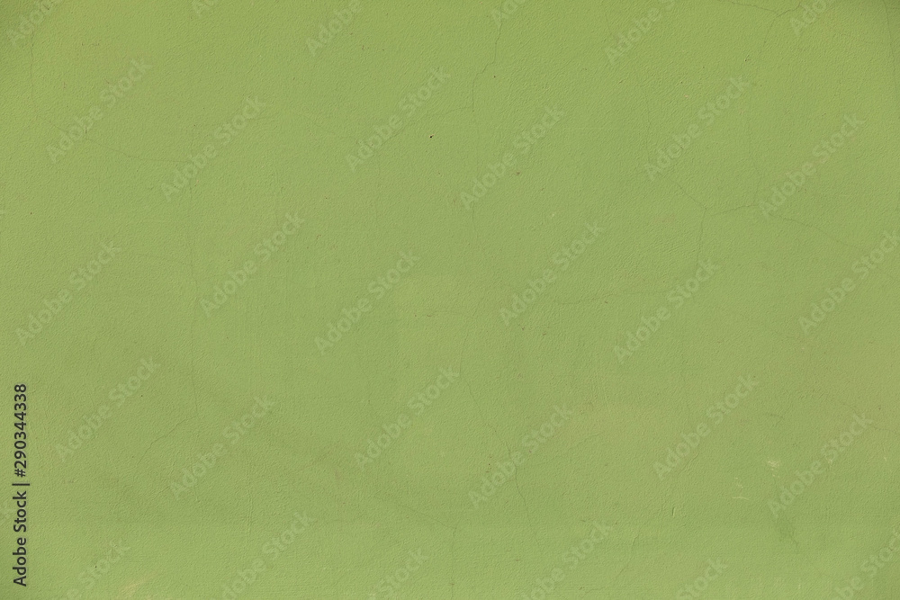 Green wall background with cracks on plaster surface