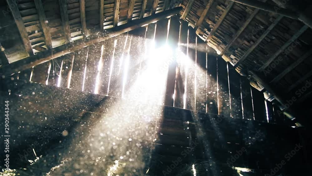 Dust flies in the rays of sunlight in the attic of the old barn HD 1920x1080