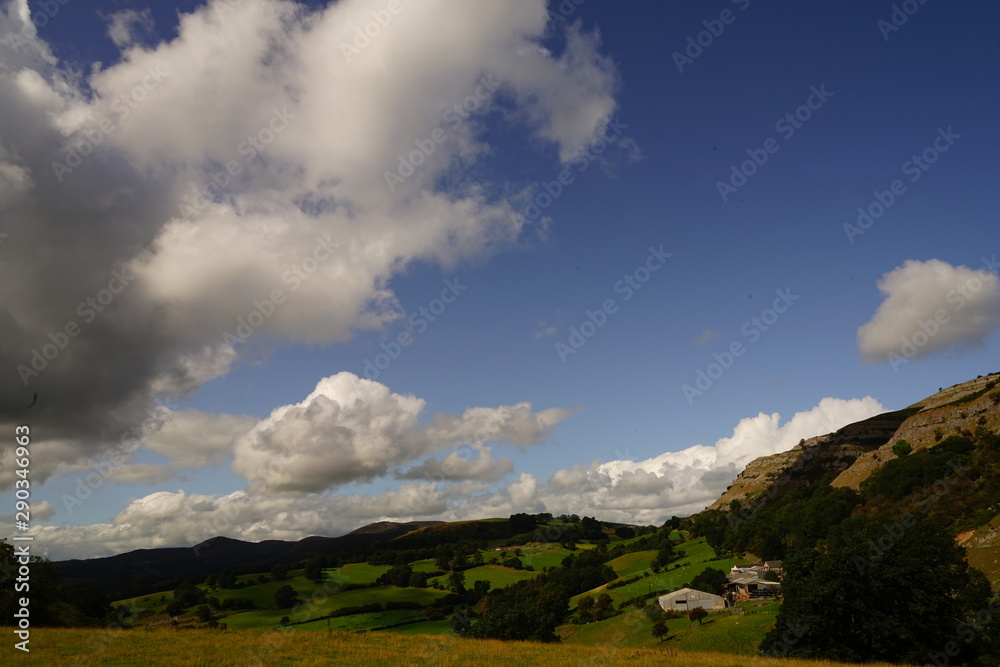 Bright Landscape of Welsh Mountains Blue Sky and White Clouds