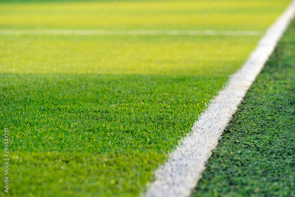 Front view of green soccer field.Beautiful artificial grass on the stadium.Abstract football turf ground background with white stripe line and corner kick.Background,Sport,Texture Concept