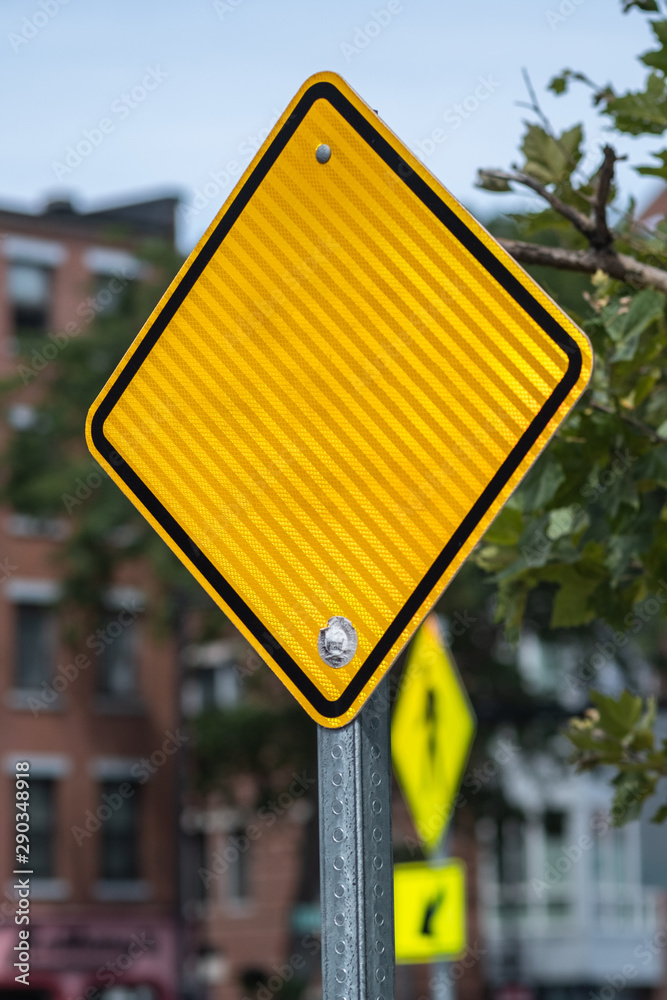 blank yellow sign on a blur background concept idea road route patch form shape line diagonal distorsion geometric perspective craft police force law stop street urban exploration