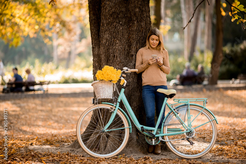 Young woman with bicycle us...