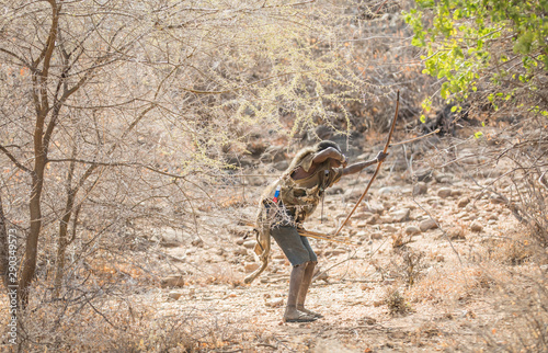 hadzabe man hunting with his bow and arrows photo