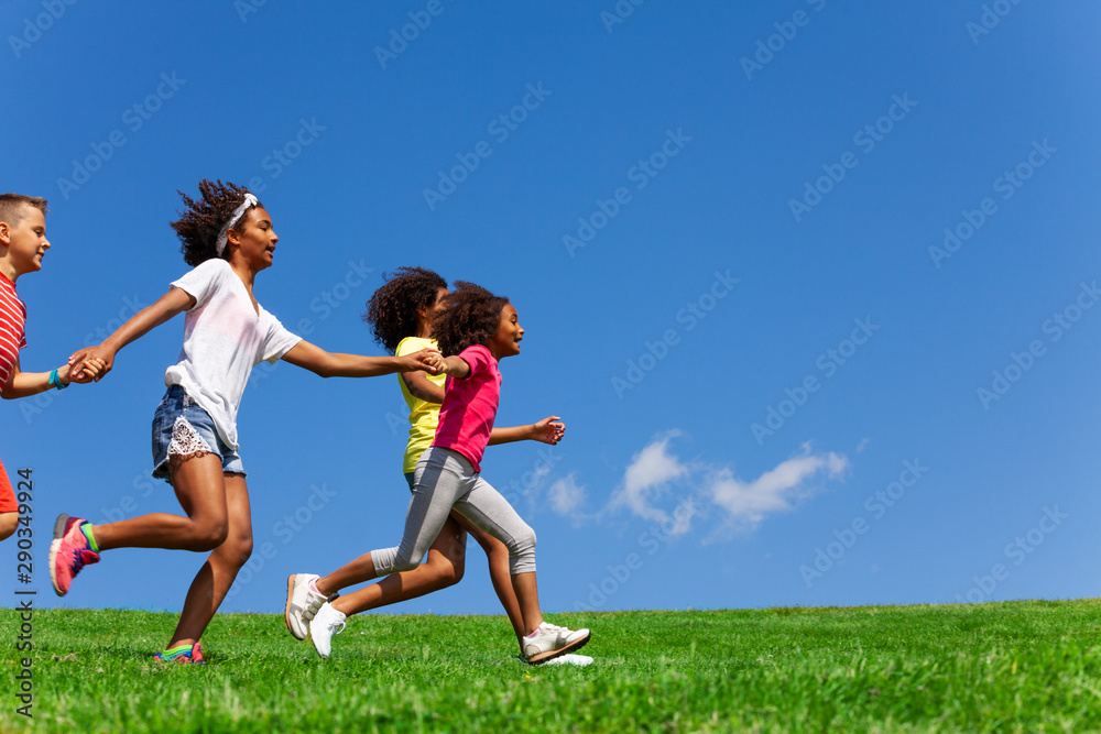 Side portrait of group with fast running kids Side portrait of group with fast running kids
