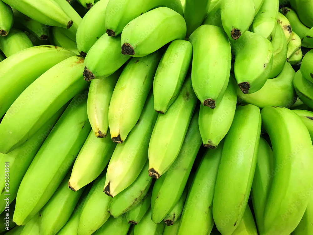 A lot of platanos on sale at farms market. Top view. Food background