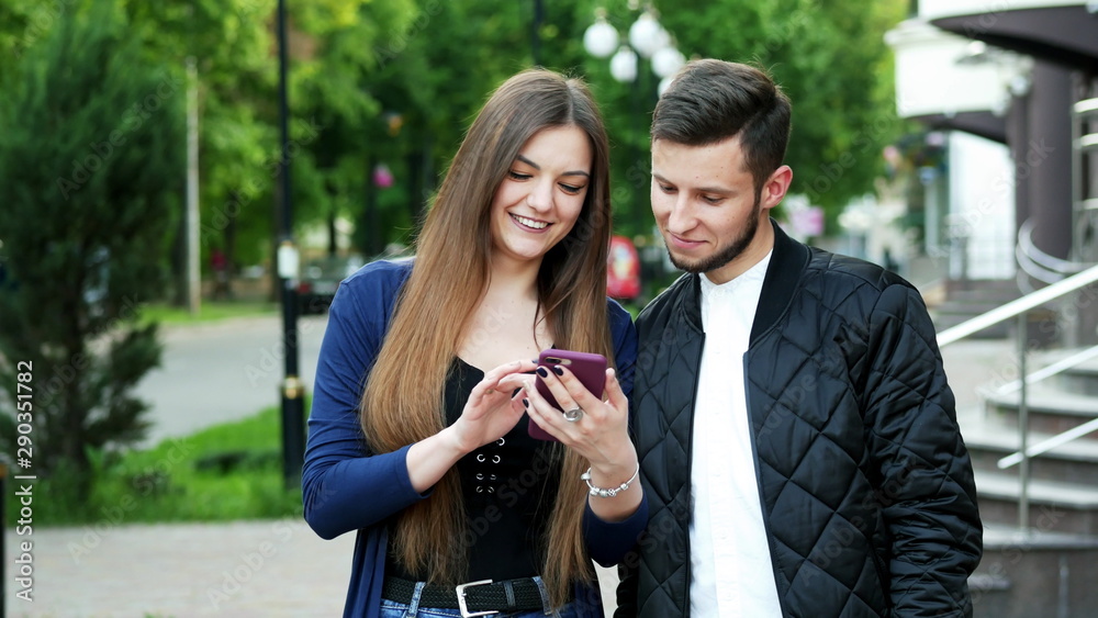 Happy couple do online shopping via phone, choose goods, make purchases in the application Happy couple do online shopping via phone, choose goods, make purchases in the application