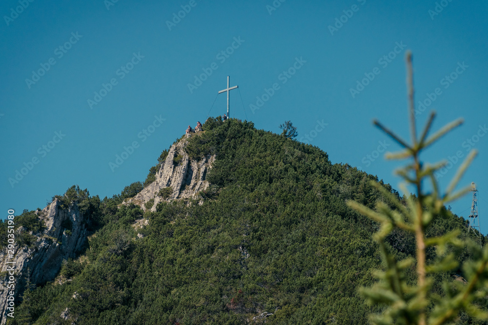 View of the cross on top of the Heimgarten mountain over lake Walchen in Bayern, Germany View of the cross on top of the Heimgarten mountain over lake Walchen in Bayern, Germany