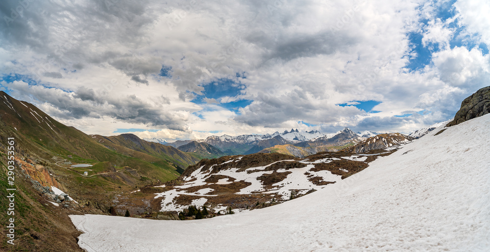Εκτύπωση καμβά Panorama of alpine valley and mountains in spring with large snowfield in the fo