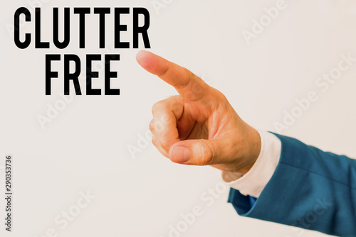 Writing note showing Clutter Free. Business concept for Well organized and arranged Tidy All things in right places Isolated hand pointing with finger. Business concept pointing finger