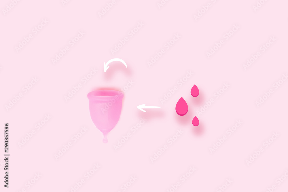 Pink menstrual cup with bood on pink background. Flat lay, top view. copy space. Pink menstrual cup with bood on pink background. Flat lay, top view. copy space.