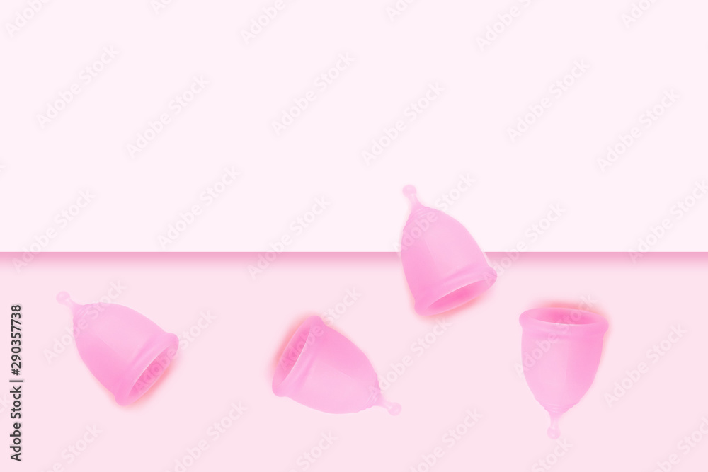 Pink menstrual cup on pink background. Flat lay, top view. copy space.