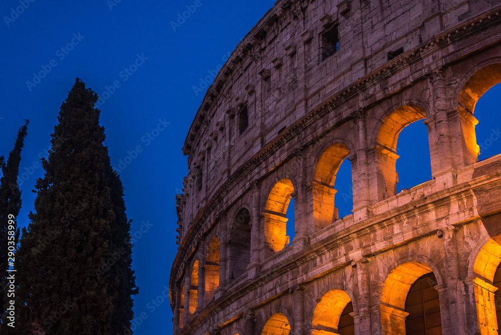 The Colosseum under the glow of lights at night, Rome