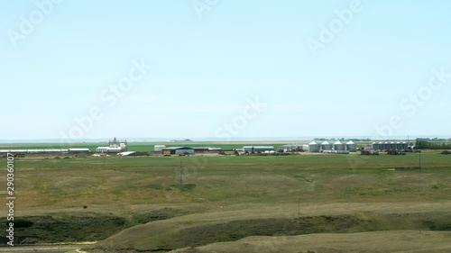 Wide zoom in on a Hutterite colony showing the buildings and farming equipment in this self-sustaining religious community. photo