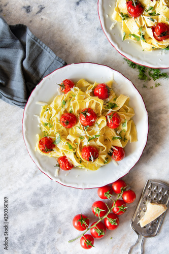 Tagliatelle pasta with oven roasted tomatoes and Parmesan cheese photo