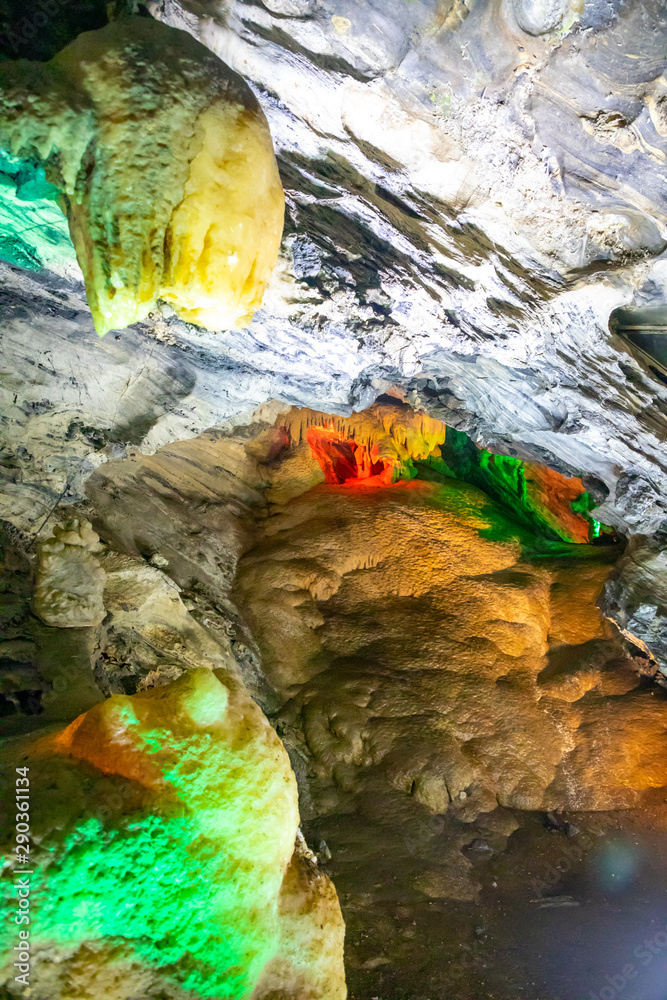 Beautiful illuminated multicolored stalactites in Danzhou Stone Flower Caves, Geopark next to Haikou, Hainan, China