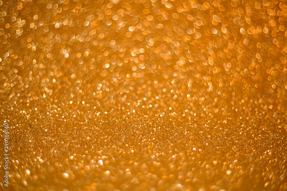 Gold giltter texture abstract background.Gold Festive Christmas twinkled bright background with bokeh defocused golden lights