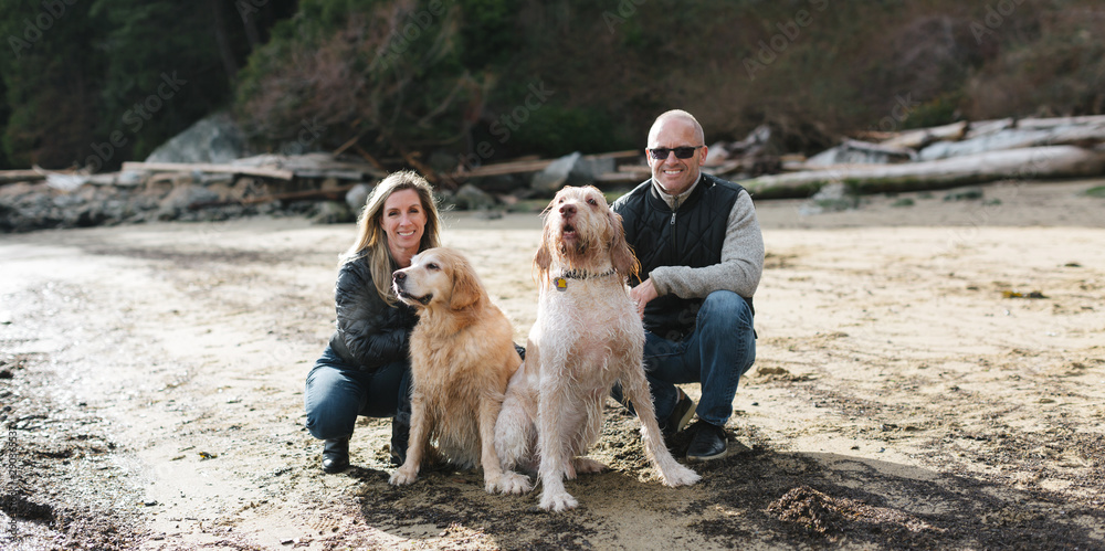 Active happy couple with dogs on a walk in nature Active happy couple with dogs on a walk in nature