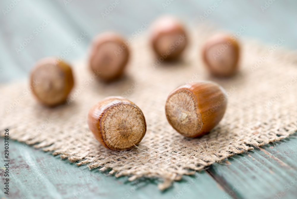 Fototapeta premium Hazelnuts and a on wooden background, christmas food