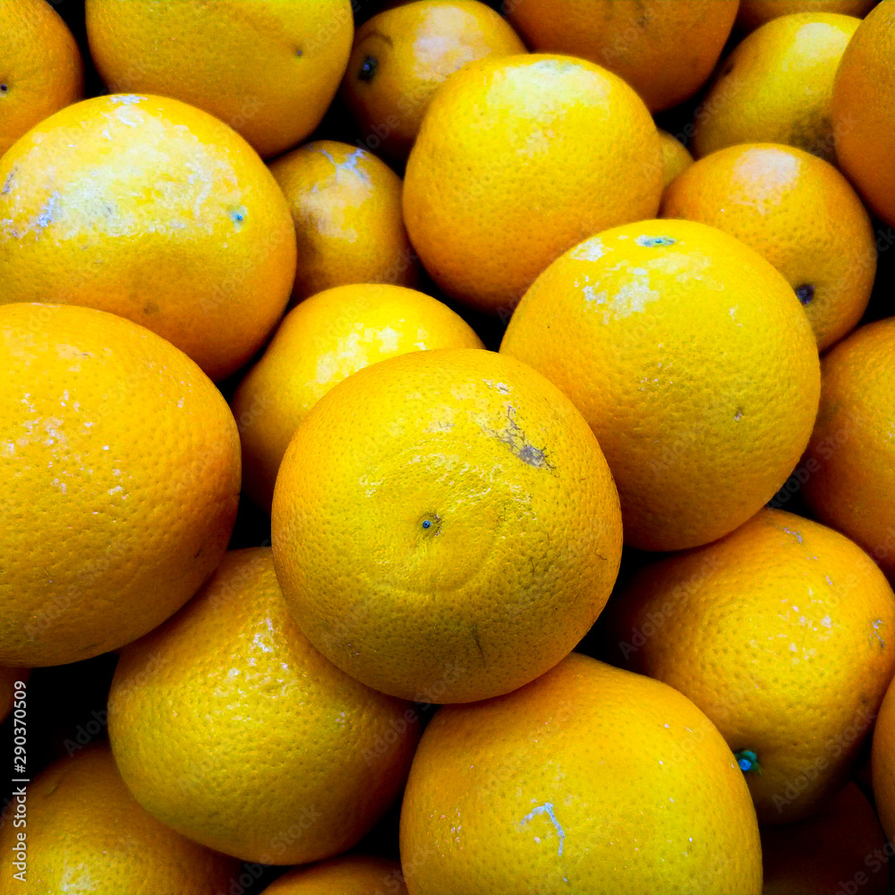 Background from oranges in the market. Ripe fruits on the counter. Background from oranges in the market. Ripe fruits on the counter.
