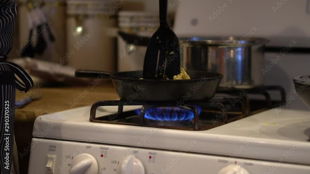 Stirring scrambled eggs in small frying pan, Slowmo Close Up