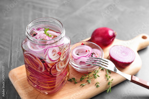 Jar of pickled onions on grey table