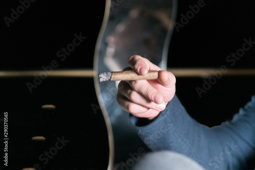 Man is sitting with a cigar