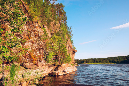 Stone cliff on the shore of lake Ladoga .